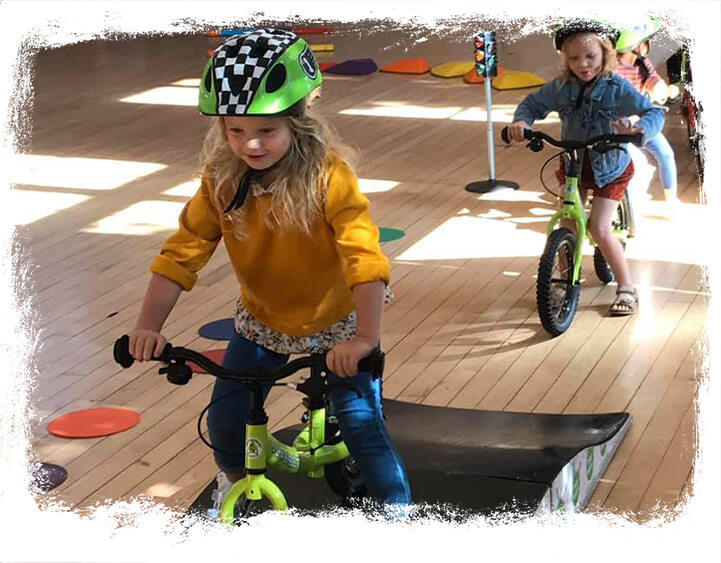 Children learning to ride bikes in a Mini Bikers course