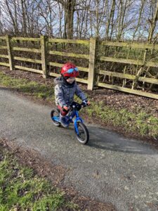 Balance bike learner smiling