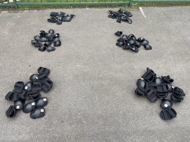 Children practising obstacle courses on scooters